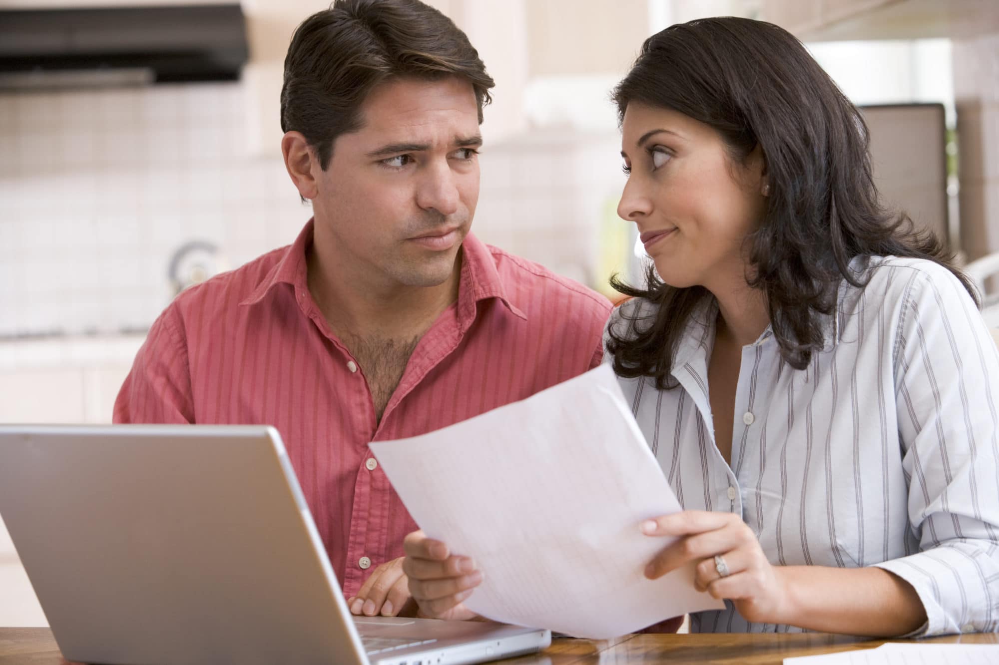 Couple looking over finances on laptop
