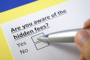 Ask questions are you aware of the hidden fees with check box for yes or no and pen hovering over the yes checkbox
